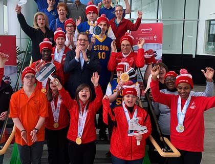 Special Olympic athletes rallying together with CEO, Michael Medline.