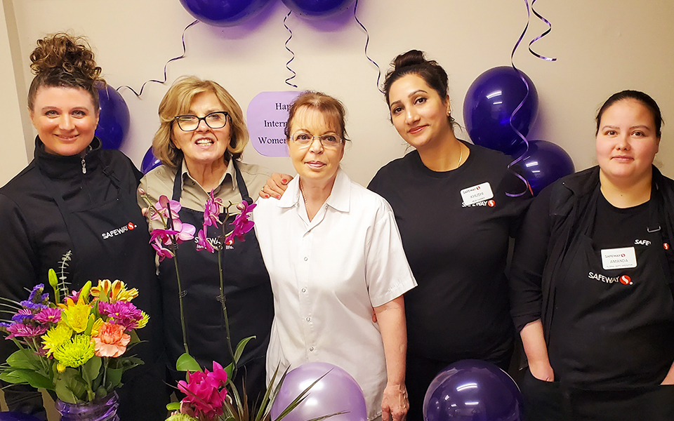 Female Safeway employees celebrating International Women's Day.