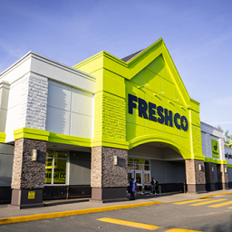 An image of a green and white building with the Frescho branding logo
