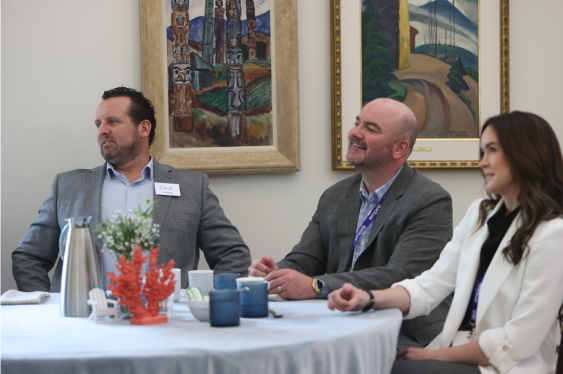 In this image, a group of Sobeys employees is discussing something together and laughing.