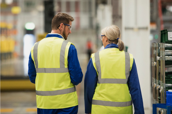 An image of safety leaders discussing something and walking together.