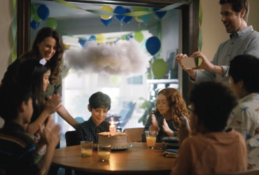 In this image, a group of people is celebrating a child's birthday.