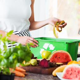 A picture shows a woman putting waste into a box.