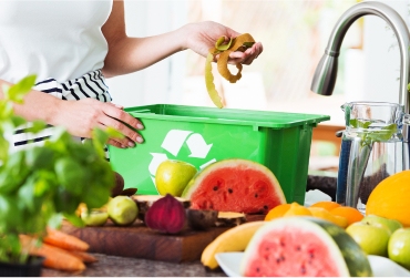 A picture shows a woman putting waste into a box.