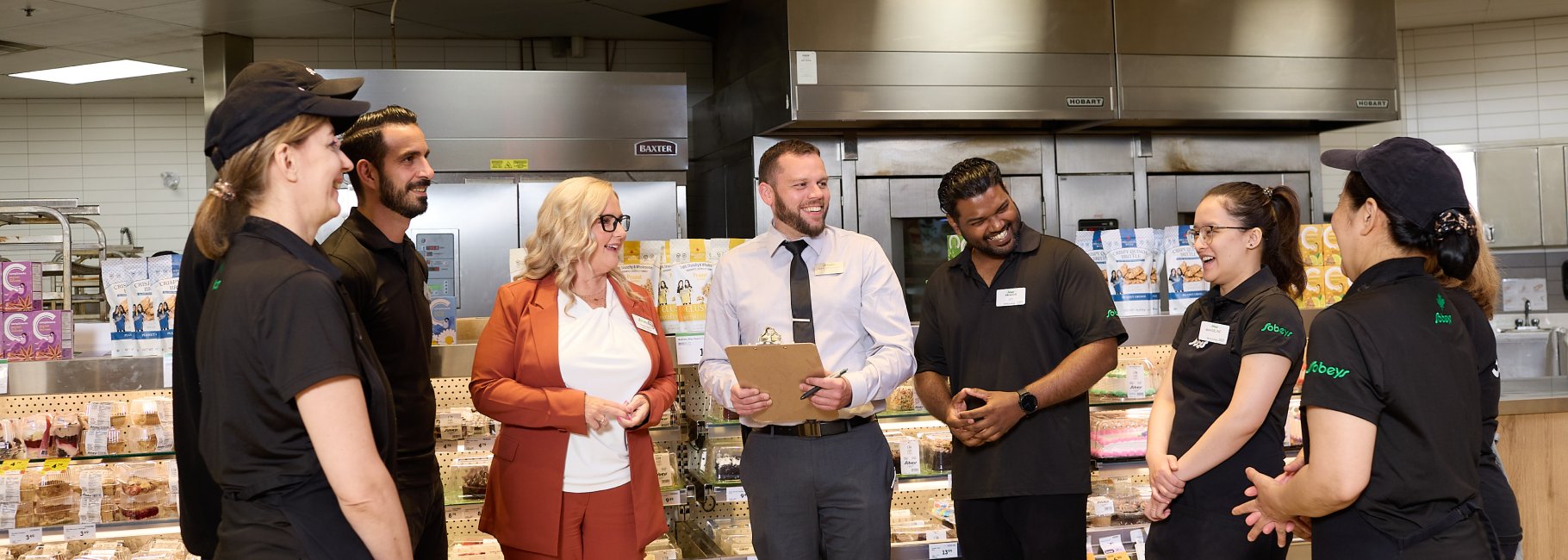 An image showing Sobeys employees standing together and smiling.